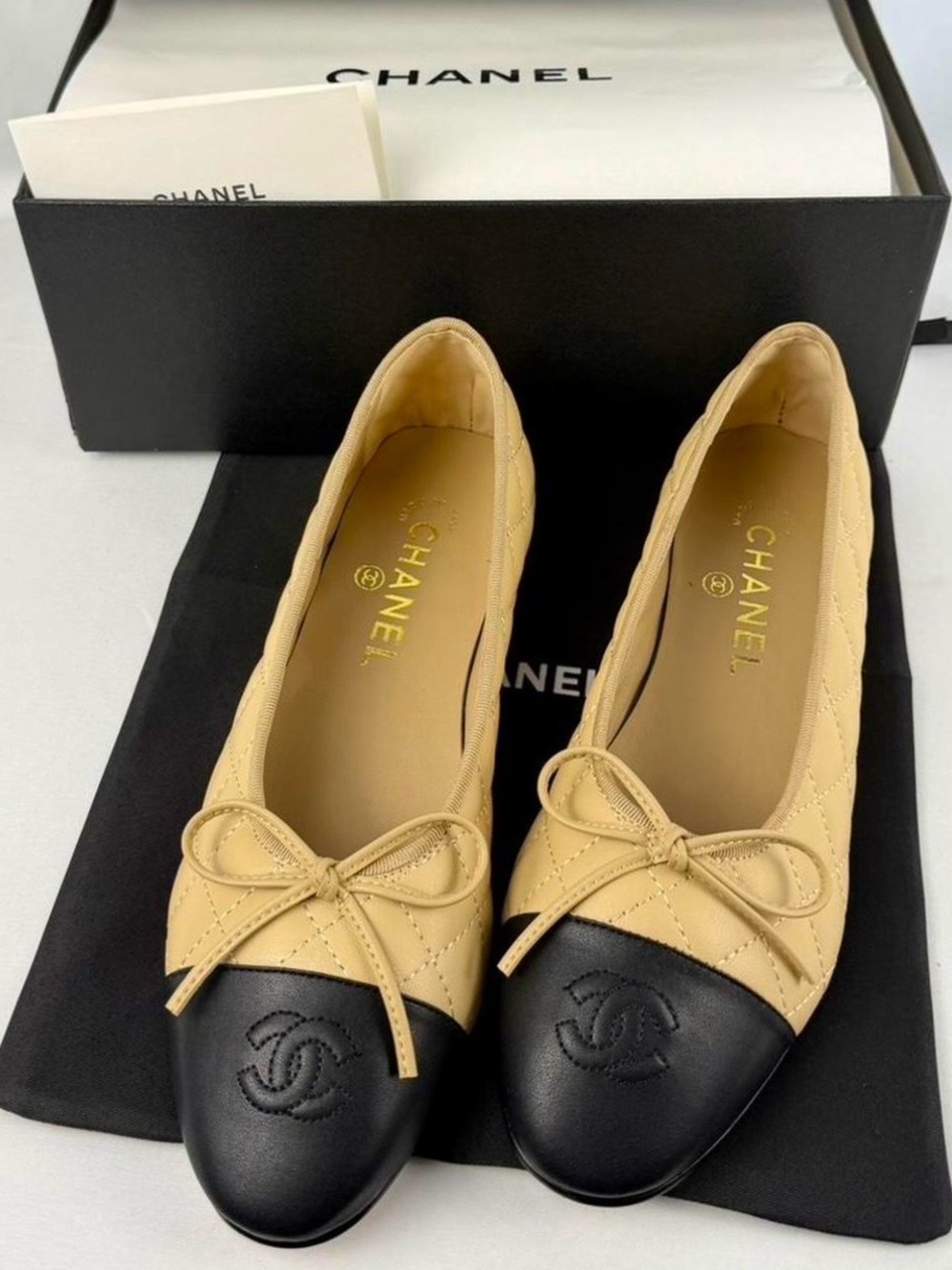 CHANEL Quilted Leather Ballet Flats in Tan and Black with Bow